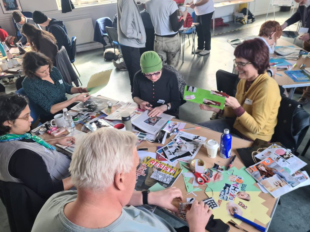 People sit around a table doing crafts. 